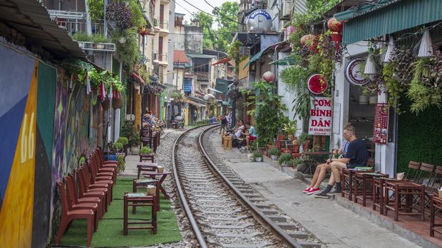 Hanoi, Vietnam - june 11, 2019:The Old Quarter, The Hanoi Street Train Tracks. Going through the narrow streets. life of locals on the street with a train