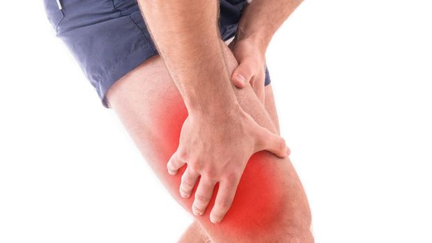 Man with quadriceps pain over white background