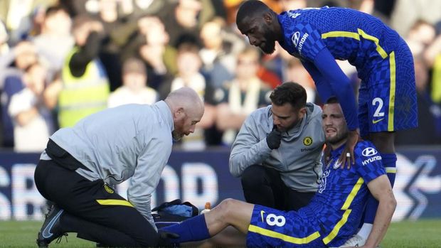 Chelsea's Mateo Kovacic is treated for an injury during the English Premier League soccer match between Leeds United and Chelsea at Elland Road in Leeds, England, Wednesday May 11, 2022. (AP Photo/Jon Super)