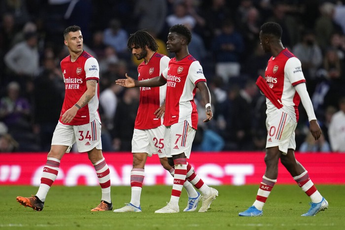 Arsenal players leave the pitch for the halftime during the English Premier League soccer match between Tottenham Hotspur and Arsenal at Tottenham Hotspur stadium in London, England, Thursday, May 12, 2022. (AP Photo/Matt Dunham)