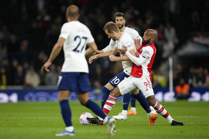 Harry Kane Tottenham's Harry Kane, center, and Arsenal's Alexandre Lacazette, right, fight for the ball during the English Premier League soccer match between Tottenham Hotspur and Arsenal at Tottenham Hotspur stadium in London, England, Thursday, May 12, 2022. (AP Photo/Matt Dunham)