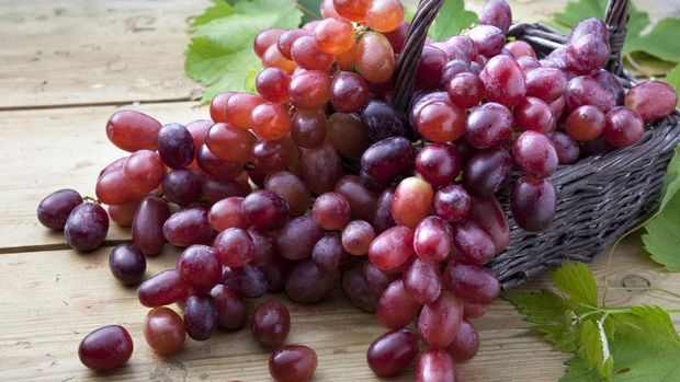 Red Grapes overflowing out of basket
