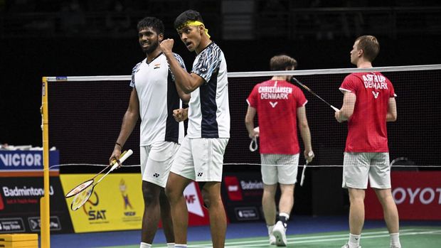 India's Satwiksairaj Rankireddy (L) and Chirag Shetty (2L) celebrate their victory over Denmark's Mathias Christiansen and Kim Astrup in the semi-finals of the Thomas and Uber Cup badminton tournament in Bangkok on May 13, 2022. (Photo by Lillian SUWANRUMPHA / AFP)