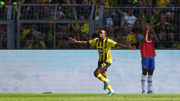 DORTMUND, GERMANY - MAY 14: Youssoufa Moukoko of Borussia Dortmund celebrates after scoring their side's second goal during the Bundesliga match between Borussia Dortmund and Hertha BSC at Signal Iduna Park on May 14, 2022 in Dortmund, Germany. (Photo by Lars Baron/Getty Images)