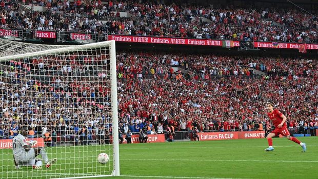 Chelsea vs Liverpool Liverpool's Greek defender Kostas Tsimikas (R) shoots and scores past Chelsea's French-born Senegalese goalkeeper Edouard Mendy (L) during the penalty sessions of the English FA Cup final football match between Chelsea and Liverpool, at Wembley stadium, in London, on May 14, 2022. - Liverpool wins the FA cup final - NOT FOR MARKETING OR ADVERTISING USE / RESTRICTED TO EDITORIAL USE (Photo by Glyn KIRK / AFP) / NOT FOR MARKETING OR ADVERTISING USE / RESTRICTED TO EDITORIAL USE (Photo by GLYN KIRK/AFP via Getty Images)