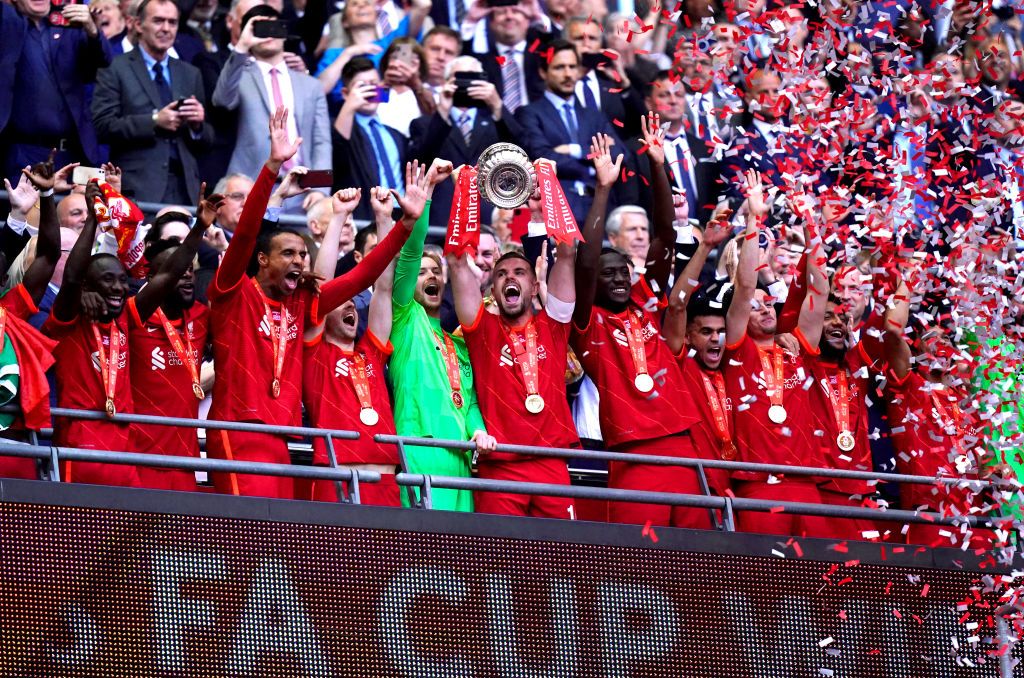 Liverpool's Jordan Henderson (centre) lifts the trophy as he celebrates with his team-mates after winning the Emirates FA Cup final at Wembley Stadium, London. Picture date: Saturday May 14, 2022. (Photo by Adam Davy/PA Images via Getty Images)
