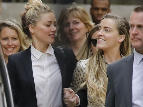 BRITAIN-US-COURT-MEDIA-DEPP US actress Amber Heard (L) leaves hand-in-hand with her sister Whitney Heard (R) from the High Court after a hearing in the libel trial by her former husband US actor Johnny Depp against News Group Newspapers (NGN) in London, on July 24, 2020. - Depp is suing the publishers of The Sun and the author of the article for the claims that called him a