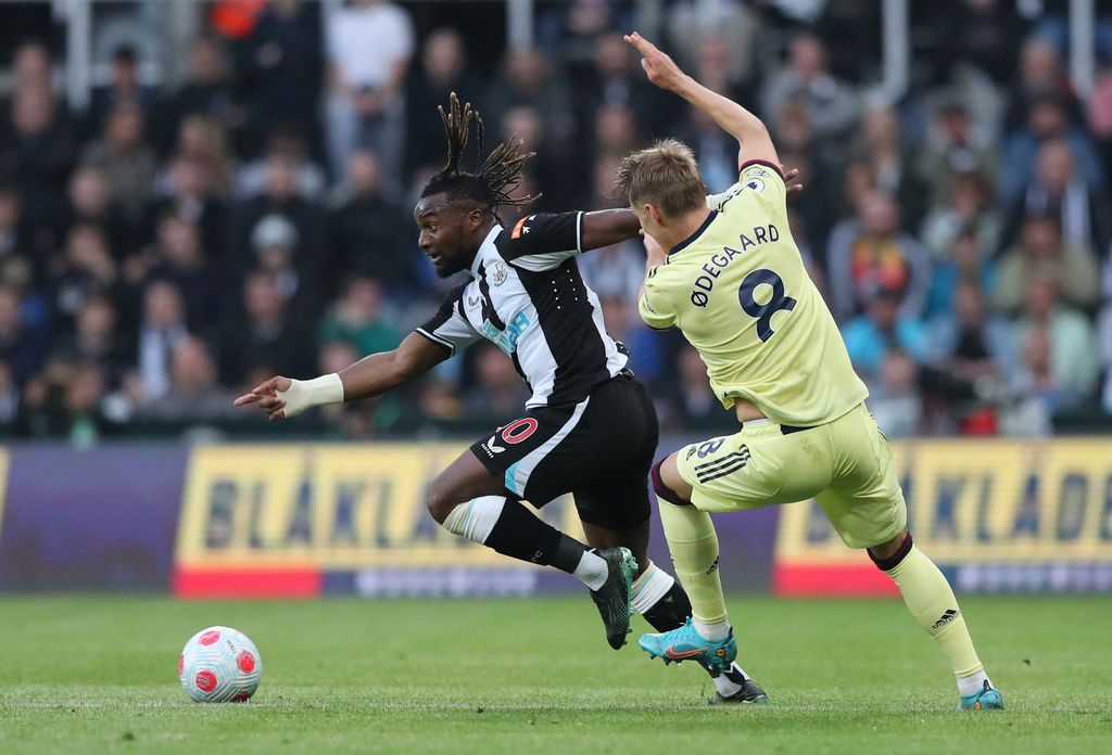 Soccer Football - Premier League - Newcastle United v Arsenal - St James' Park, Newcastle, Britain - May 16, 2022 Newcastle United's Allan Saint-Maximin in action with Arsenal's Martin Odegaard REUTERS/Scott Heppell EDITORIAL USE ONLY. No use with unauthorized audio, video, data, fixture lists, club/league logos or 'live' services. Online in-match use limited to 75 images, no video emulation. No use in betting, games or single club /league/player publications.  Please contact your account representative for further details.