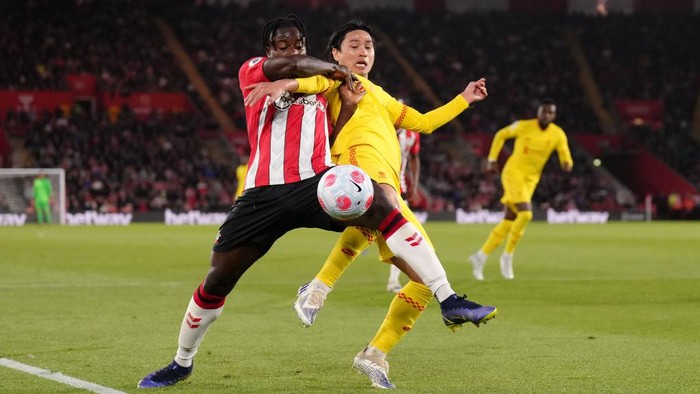 Southampton's Mohammed Salisu and Liverpool's Takumi Minamino (right) battle for the ball during the Premier League match at St Mary's Stadium, Southampton. Picture date: Tuesday May 17, 2022. (Photo by John Walton/PA Images via Getty Images)