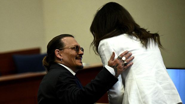 US actor Johnny Depp speaks to attorney Camille Vasquez in the courtroom at the Fairfax County Circuit Courthouse in Fairfax, Virginia, on May 17, 2022. Depp is suing ex-wife Amber Heard for libel after she wrote an op-ed piece in The Washington Post in 2018 referring to herself as a “public figure representing domestic abuse.”BRENDAN SMIALOWSKI / POOL / AFP