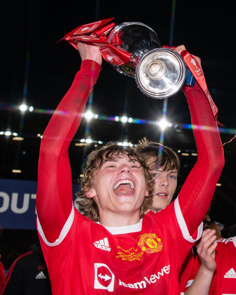 MANCHESTER, ENGLAND - MAY 11: Isak Hansen-Aaroen of Manchester United U18s lifts the trophy after the FA Youth Cup Final between Manchester United U18s and Nottingham Forest U18s at Old Trafford on May 11, 2022 in Manchester, England. (Photo by Ash Donelon/Manchester United via Getty Images)