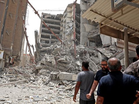 Iranians gather at the site where a ten-storey building collapsed in the southwestern city of Abadan on May 23, 2022. At least four people died and about 80 were trapped under rubble when an unfinished building collapsed in southwestern Iran, officials said.