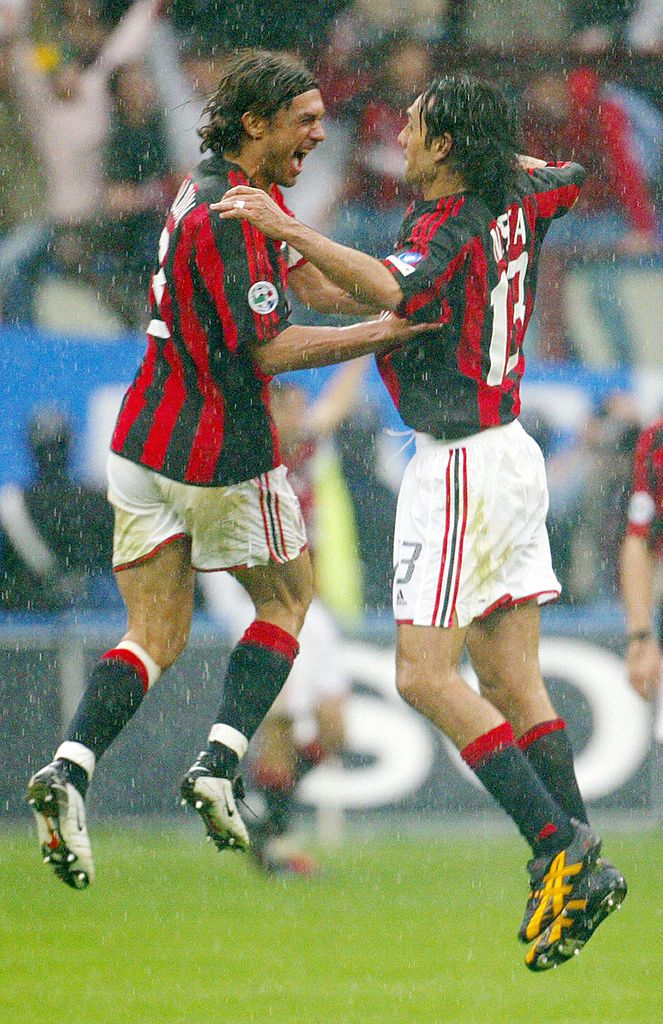 MILAN, ITALY:  AC Milan's captain Paolo Maldini (L) jubilates with his teammate Alessandro Nesta at the end of their Italian Serie A football match against AS Roma in Milan's San Siro stadium, 02 May 2004. AC Milan won the match 1-0 and the Italian championship.  AFP PHOTO/ Patrick HERTZOG  (Photo credit should read PATRICK HERTZOG/AFP via Getty Images)