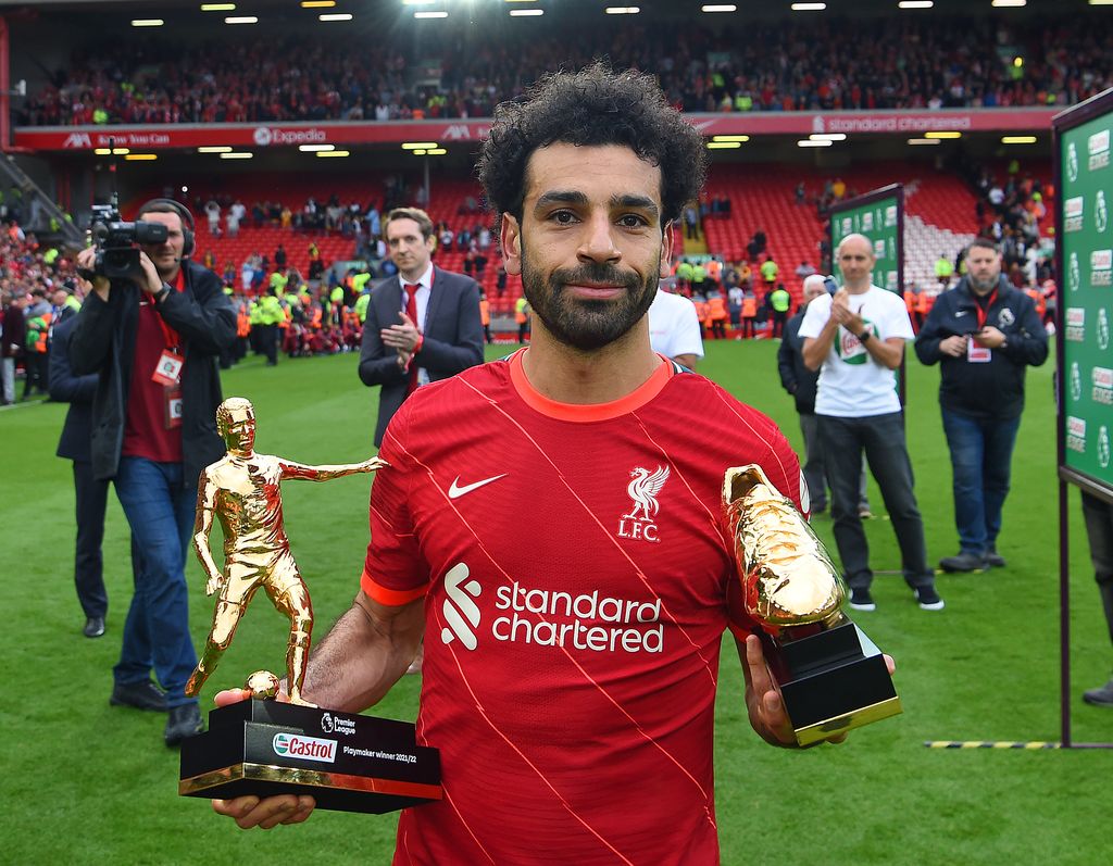LIVERPOOL, ENGLAND - MAY 22: (THE SUN OUT.THE SUN ON SUNDAY OUT)  Mohamed Salah of Liverpool with the Playmaker and the Golden Boot trophies at the end of the Premier League match between Liverpool and Wolverhampton Wanderers at Anfield on May 22, 2022 in Liverpool, England. (Photo by John Powell/Liverpool FC via Getty Images)