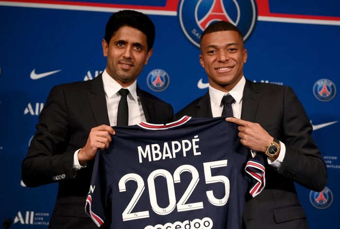 Paris Saint-Germain's French forward Kylian Mbappe poses with a jersey at the end of a press conference at the Parc des Princes stadium in Paris on May 23, 2022, two days after the club won the Ligue 1 title for a record-equalling tenth time and its superstar striker Mbappe chose to sign a new contract until 2025 at PSG rather than join Real Madrid. (Photo by FRANCK FIFE / AFP) (Photo by FRANCK FIFE/AFP via Getty Images)