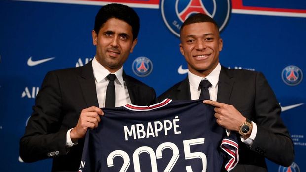 Paris Saint-Germain's French forward Kylian Mbappe poses with a jersey at the end of a press conference at the Parc des Princes stadium in Paris on May 23, 2022, two days after the club won the Ligue 1 title for a record-equalling tenth time and its superstar striker Mbappe chose to sign a new contract until 2025 at PSG rather than join Real Madrid. (Photo by FRANCK FIFE / AFP) (Photo by FRANCK FIFE/AFP via Getty Images)