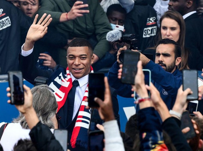 Paris Saint-Germain's French forward Kylian Mbappe poses with a jersey at the end of a press conference at the Parc des Princes stadium in Paris on May 23, 2022, two days after the club won the Ligue 1 title for a record-equalling tenth time and its superstar striker Mbappe chose to sign a new contract until 2025 at PSG rather than join Real Madrid. (Photo by FRANCK FIFE / AFP) (Photo by FRANCK FIFE/AFP via Getty Images)