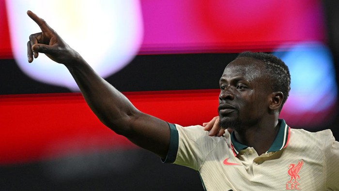 Liverpools Senegalese striker Sadio Mane celebrates scoring the teams second goal during the English Premier League football match between Aston Villa and Liverpool at Villa Park in Birmingham, central England on May 10, 2022. - RESTRICTED TO EDITORIAL USE. No use with unauthorized audio, video, data, fixture lists, club/league logos or live services. Online in-match use limited to 120 images. An additional 40 images may be used in extra time. No video emulation. Social media in-match use limited to 120 images. An additional 40 images may be used in extra time. No use in betting publications, games or single club/league/player publications. (Photo by Paul ELLIS / AFP) / RESTRICTED TO EDITORIAL USE. No use with unauthorized audio, video, data, fixture lists, club/league logos or live services. Online in-match use limited to 120 images. An additional 40 images may be used in extra time. No video emulation. Social media in-match use limited to 120 images. An additional 40 images may be used in extra time. No use in betting publications, games or single club/league/player publications. / RESTRICTED TO EDITORIAL USE. No use with unauthorized audio, video, data, fixture lists, club/league logos or live services. Online in-match use limited to 120 images. An additional 40 images may be used in extra time. No video emulation. Social media in-match use limited to 120 images. An additional 40 images may be used in extra time. No use in betting publications, games or single club/league/player publications. (Photo by PAUL ELLIS/AFP via Getty Images)