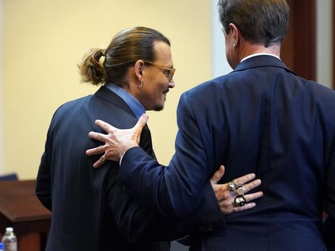 Actor Johnny Depp embraces his attorney Benjamin Chew after closing arguments at the Fairfax County Circuit Courthouse in Fairfax, Va., Friday, May 27, 2022. Depp sued his ex-wife Amber Heard for libel in Fairfax County Circuit Court after she wrote an op-ed piece in The Washington Post in 2018 referring to herself as a 