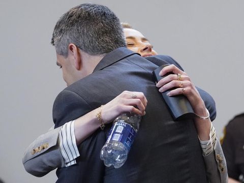 Actor Amber Heard hugs her attorney Benjamin Rottenborn in the courtroom at the Fairfax County Circuit Courthouse in Fairfax, Va., Friday, May 27, 2022. Actor Johnny Depp sued his ex-wife Amber Heard for libel in Fairfax County Circuit Court after she wrote an op-ed piece in The Washington Post in 2018 referring to herself as a 