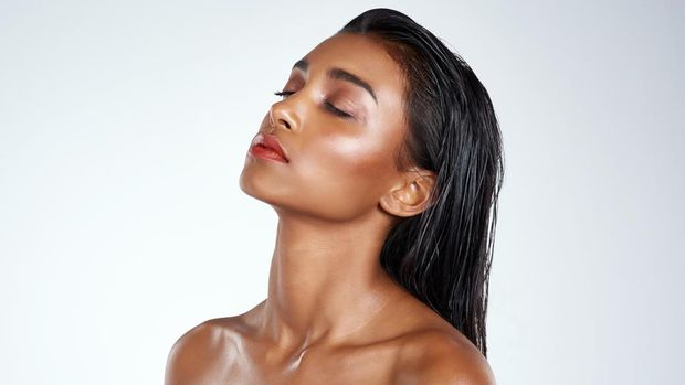 Studio shot of a beautiful young woman posing against a light background