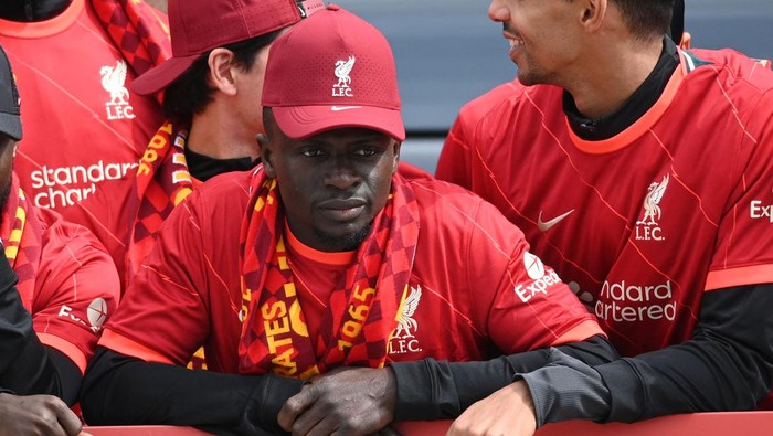 Liverpools Senegalese striker Sadio Mane reacts as he stands among temmates on an open-top bus during a parade through the streets of Liverpool in north-west England on May 29, 2022, to celebrate winning the 2021-22 League Cup and FA Cup. - Despite the disappointment of losing to real Madrid in the final of the UEAF Champions League, Klopp has called on Liverpool fans to take to the streets of the city on Sunday when they parade the League Cup and FA Cup. (Photo by Oli SCARFF / AFP) (Photo by OLI SCARFF/AFP via Getty Images)