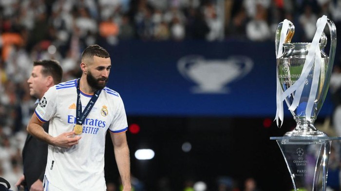 Real Madrids French forward Karim Benzema walks past hte trophy after winning the UEFA Champions League final football match between Liverpool and Real Madrid at the Stade de France in Saint-Denis, north of Paris, on May 28, 2022. (Photo by FRANCK FIFE / AFP) (Photo by FRANCK FIFE/AFP via Getty Images)