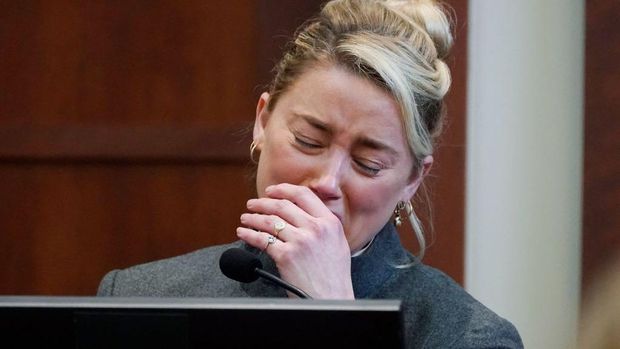 Actor Amber Heard reacts as a pre-recorded deposition testimony of Christian Carino is played during her ex-husband Johnny Depp's defamation trial against her, at the Fairfax County Circuit Courthouse in Fairfax, Virginia, April 27, 2022. - US actor Johnny Depp sued his ex-wife Amber Heard for libel in Fairfax County Circuit Court after she wrote an op-ed piece in The Washington Post in 2018 referring to herself as a 