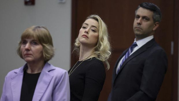 Actor Amber Heard and her attorneys Elaine Bredehoft and Benjamin Rottenborn look over to the jury, just before the jury announced that they believe she defamed ex-husband Johnny Depp while announcing split verdicts in favor of both her ex-husband Johnny Depp and Heard on their claim and counter-claim in the Depp v. Heard civil defamation trial at the Fairfax County Circuit Courthouse in Fairfax, Virginia, U.S., June 1, 2022. REUTERS/Evelyn Hockstein/Pool
