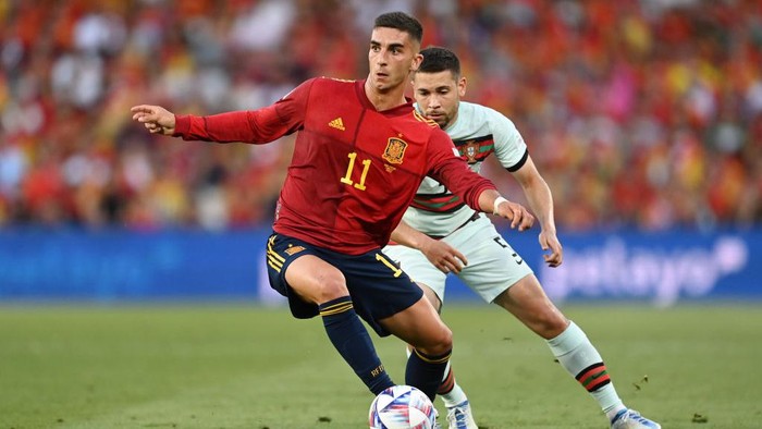SEVILLE, SPAIN - JUNE 02: Ferran Torres of Spain battles for possession with Raphael Guerreiro of Portugal during the UEFA Nations League League A Group 2 match between Spain and Portugal at Estadio Benito Villamarin on June 02, 2022 in Seville, Spain. (Photo by David Ramos/Getty Images)