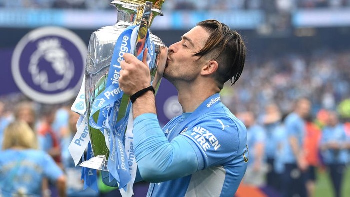   Jack Grealish of Manchester City celebrates with the Premier League trophy after their side finished the season as Premier League champions after the Premier League match between Manchester City and Aston Villa at Etihad Stadium on May 22, 2022 in Manchester, England. (Photo by Shaun Botterill/Getty Images)