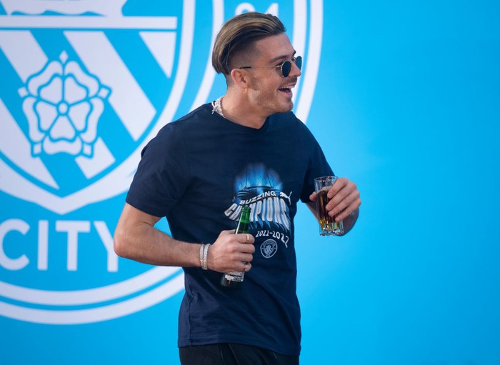 MANCHESTER, ENGLAND - MAY 22:  Jack Grealish of Manchester City celebrates with the Premier League trophy after their side finished the season as Premier League champions after the Premier League match between Manchester City and Aston Villa at Etihad Stadium on May 22, 2022 in Manchester, England. (Photo by Shaun Botterill/Getty Images)