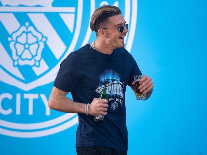 MANCHESTER, ENGLAND - MAY 22:  Jack Grealish of Manchester City celebrates with the Premier League trophy after their side finished the season as Premier League champions after the Premier League match between Manchester City and Aston Villa at Etihad Stadium on May 22, 2022 in Manchester, England. (Photo by Shaun Botterill/Getty Images)