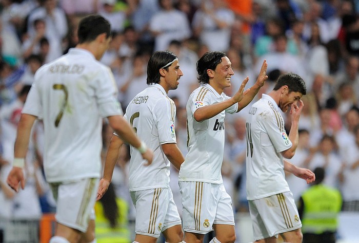 MADRID, SPAIN - MAY 13:  Mesut Ozil (2nd R) of Real Madrid CF celebrates scoring their fourth goal with Sami Khedira (2nd L) and Karim Benzema during the La Liga match between Real Madrid CF and RCD Mallorca at Estadio Santiago Bernabeu on May 13, 2012 in Madrid, Spain.  (Photo by Denis Doyle/Getty Images)