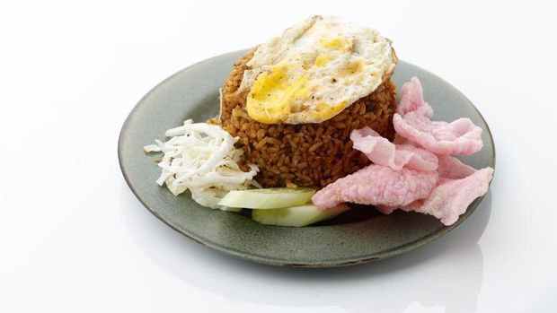 Nasi Goreng Rendang, Fried Rice with Beef Stew and Sunny Side Up Egg. Isolated on White