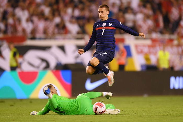 SPLIT, CROATIA - JUNE 06: Antoine Griezmann of France is challenged by Dominik Livakovic of Croatia during the UEFA Nations League League A Group 1 match between Croatia and France at Stadion Poljud on June 06, 2022 in Split, Croatia. (Photo by Jurij Kodrun/Getty Images)