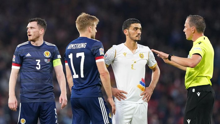 Referee Sebastian Gishamer speaks to Scotlands Stuart Armstrong and Armenias Arman Hovhannisyan during the UEFA Nations League match at Hampden Park, Glasgow. Picture date: Wednesday June 8, 2022. (Photo by Andrew Milligan/PA Images via Getty Images)