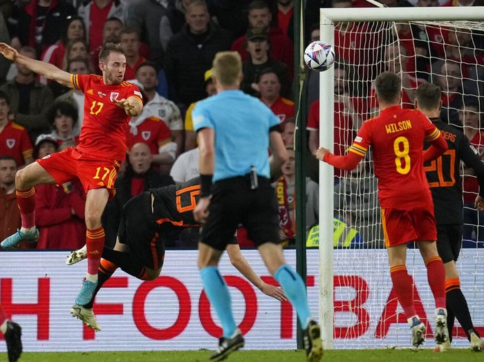 Wales's Rhys Norrington-Davies, front, duels for the ball with Netherlands' Hans Hateboer during the UEFA Nations League soccer match between Wales and the Netherlands at Cardiff City Stadium, in Cardiff, Wales, Wednesday, June 8, 2022. (AP Photo/Matt Dunham )