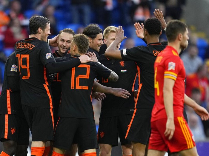Wales's Rhys Norrington-Davies, front, duels for the ball with Netherlands' Hans Hateboer during the UEFA Nations League soccer match between Wales and the Netherlands at Cardiff City Stadium, in Cardiff, Wales, Wednesday, June 8, 2022. (AP Photo/Matt Dunham )