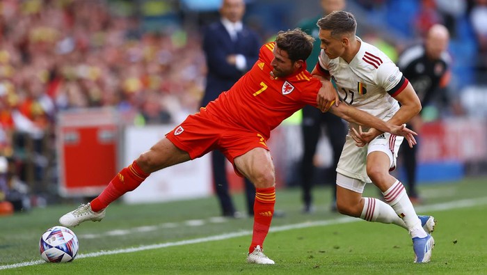 CARDIFF, WALES - JUNE 11: Joe Allen of Wales is challenged by Leandro Trossard of Belgium during the UEFA Nations League League A Group 4 match between Wales and Belgium at Cardiff City Stadium on June 11, 2022 in Cardiff, Wales. (Photo by Michael Steele/Getty Images)