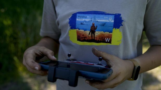 Andriy Pokrasa, 15, flies his drone during an interview with The Associated Press in Kyiv, Ukraine, Saturday, June 11, 2022. Andriy is being hailed in Ukraine for stealthy aerial reconnaissance work he has done with his dad in the ongoing war with Russia. They used their drone to help the country's military spot, locate and destroy Russian targets in the early days of the Russian invasion. (AP Photo/Natacha Pisarenko)