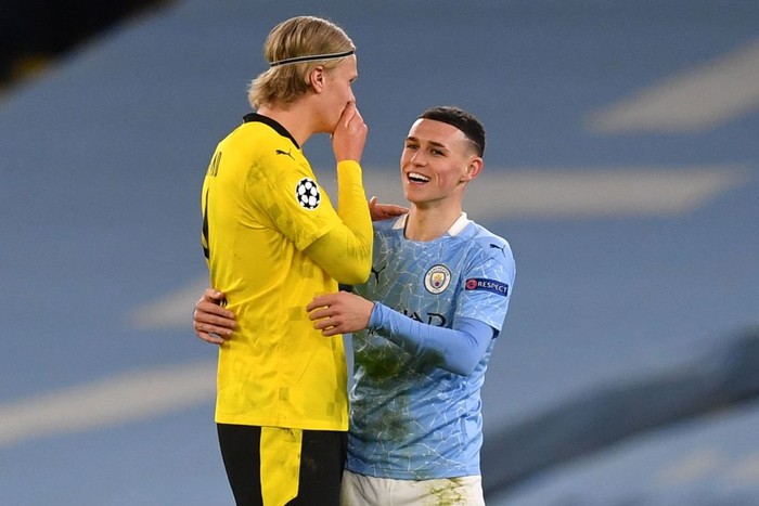 Manchester Citys English midfielder Phil Foden (R) walks off the pitch with Dortmunds Norwegian forward Erling Braut Haaland after  the UEFA Champions League first leg quarter-final football match between Manchester City and Borussia Dortmund at the Etihad Stadium in Manchester, north west England, on April 6, 2021. (Photo by Paul ELLIS / AFP) (Photo by PAUL ELLIS/AFP via Getty Images)