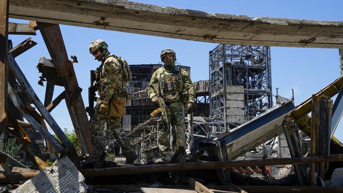 Russian soldiers walk through the debris of the Metallurgical Combine Azovstal, in Mariupol, on the territory which is under the Government of the Donetsk Peoples Republic control, eastern Ukraine, Monday, June 13, 2022. The plant was almost completely destroyed during the siege of Mariupol. This photo was taken during a trip organized by the Russian Ministry of Defense. (AP Photo)