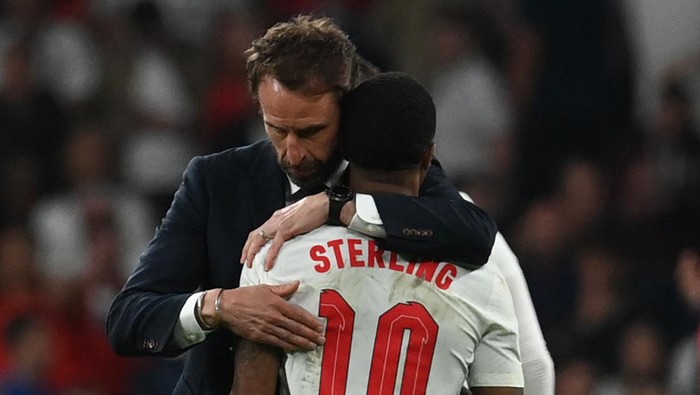 TOPSHOT - Englands coach Gareth Southgate embraces Englands forward Raheem Sterling after the UEFA EURO 2020 final football match between Italy and England at the Wembley Stadium in London on July 11, 2021. (Photo by Paul ELLIS / POOL / AFP) (Photo by PAUL ELLIS/POOL/AFP via Getty Images)