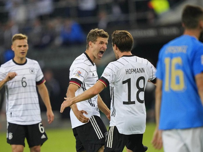 Germany's keeper Manuel Neuer receives a goal from Italy's Degnand Gnonto, left, during the UEFA Nations League soccer match between Germany and Italy in Moenchengladbach, Germany, Tuesday, June 14, 2022. (AP Photo/Martin Meissner)