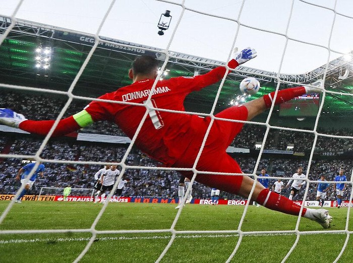 Germany's keeper Manuel Neuer receives a goal from Italy's Degnand Gnonto, left, during the UEFA Nations League soccer match between Germany and Italy in Moenchengladbach, Germany, Tuesday, June 14, 2022. (AP Photo/Martin Meissner)