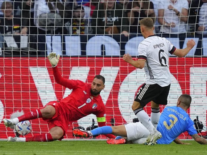 Germany's keeper Manuel Neuer receives a goal from Italy's Degnand Gnonto, left, during the UEFA Nations League soccer match between Germany and Italy in Moenchengladbach, Germany, Tuesday, June 14, 2022. (AP Photo/Martin Meissner)