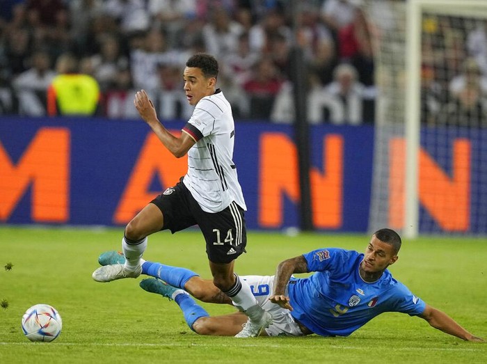 Germany's keeper Manuel Neuer receives a goal from Italy's Degnand Gnonto, left, during the UEFA Nations League soccer match between Germany and Italy in Moenchengladbach, Germany, Tuesday, June 14, 2022. (AP Photo/Martin Meissner)