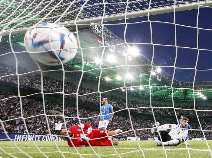 Germany's keeper Manuel Neuer receives a goal from Italy's Degnand Gnonto, left, during the UEFA Nations League soccer match between Germany and Italy in Moenchengladbach, Germany, Tuesday, June 14, 2022. (AP Photo/Martin Meissner)
