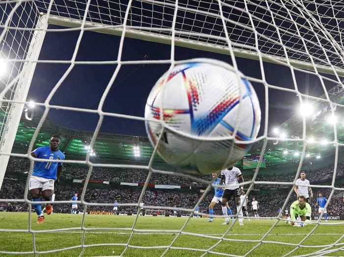 Germany's keeper Manuel Neuer receives a goal from Italy's Degnand Gnonto, left, during the UEFA Nations League soccer match between Germany and Italy in Moenchengladbach, Germany, Tuesday, June 14, 2022. (AP Photo/Martin Meissner)